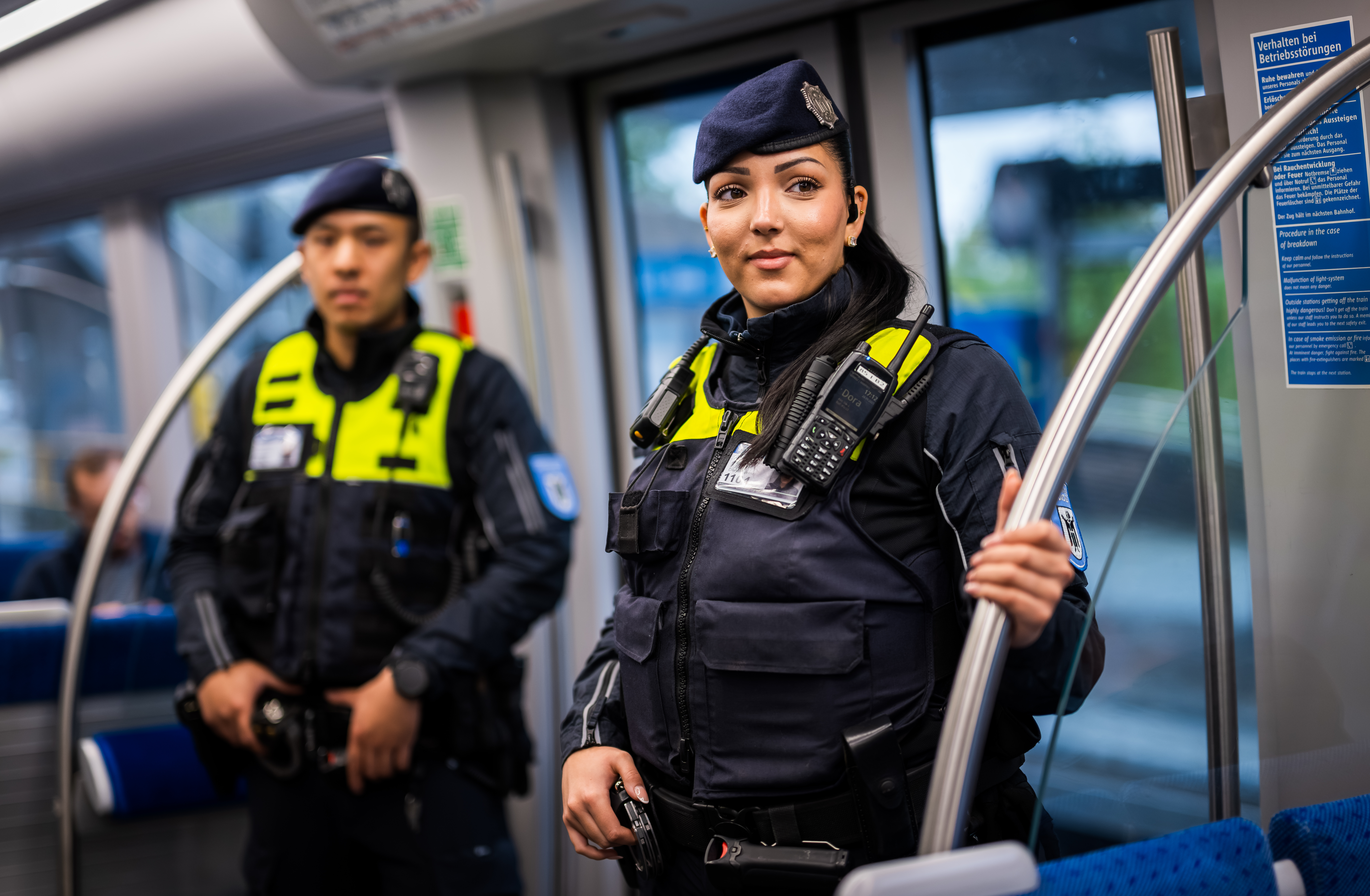 A female and a male M&uuml;nchner U-Bahnwache guard in a train.