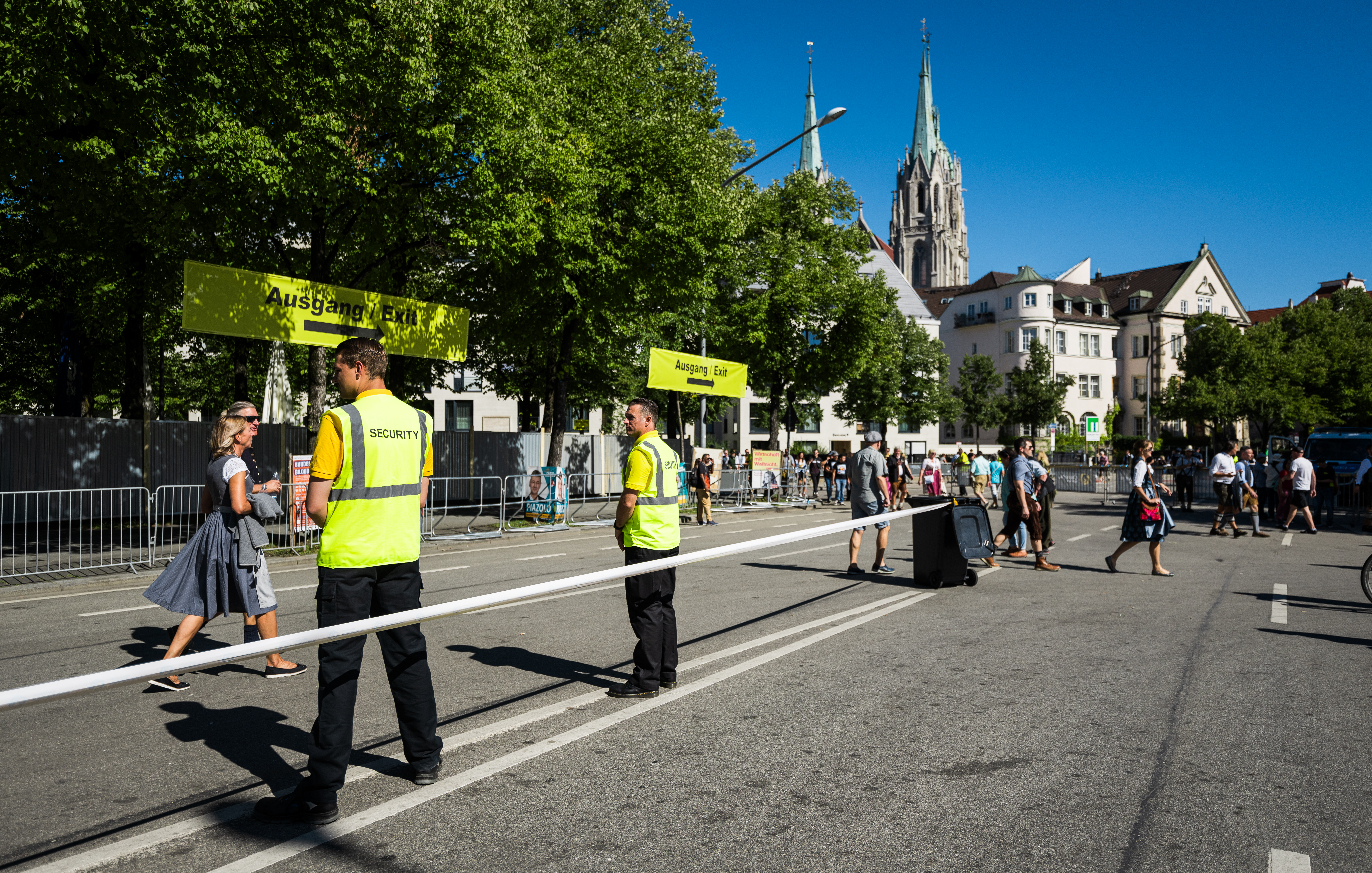 Security guards standing along roped off street at Oktoberfest.
